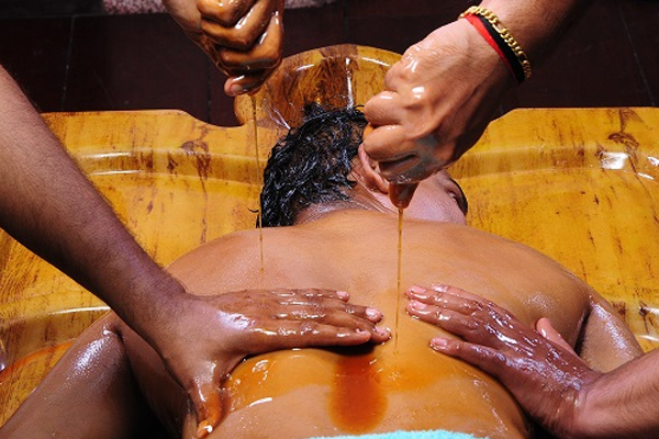 Pizhichil Ayurvedic therapy with warm herbal oil